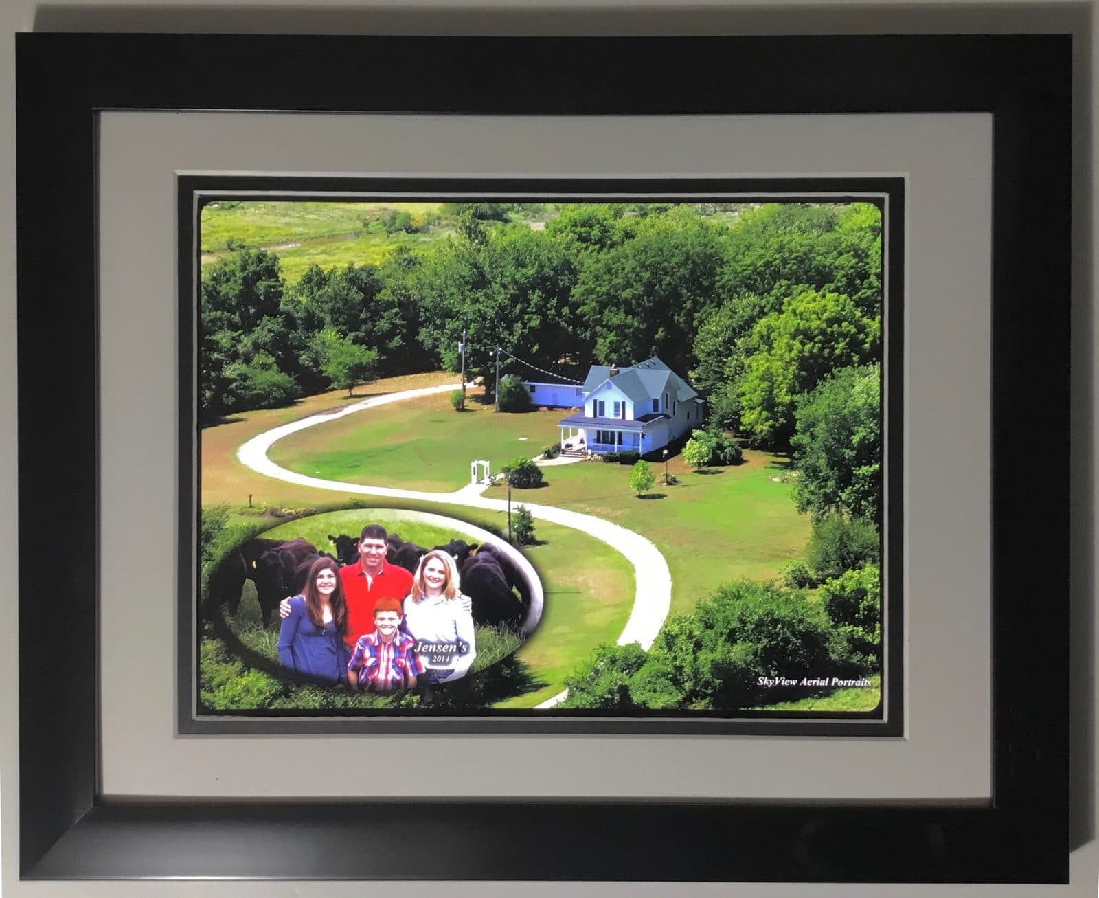 A framed aerial print of a family farm, delivered by SkyView Portraits